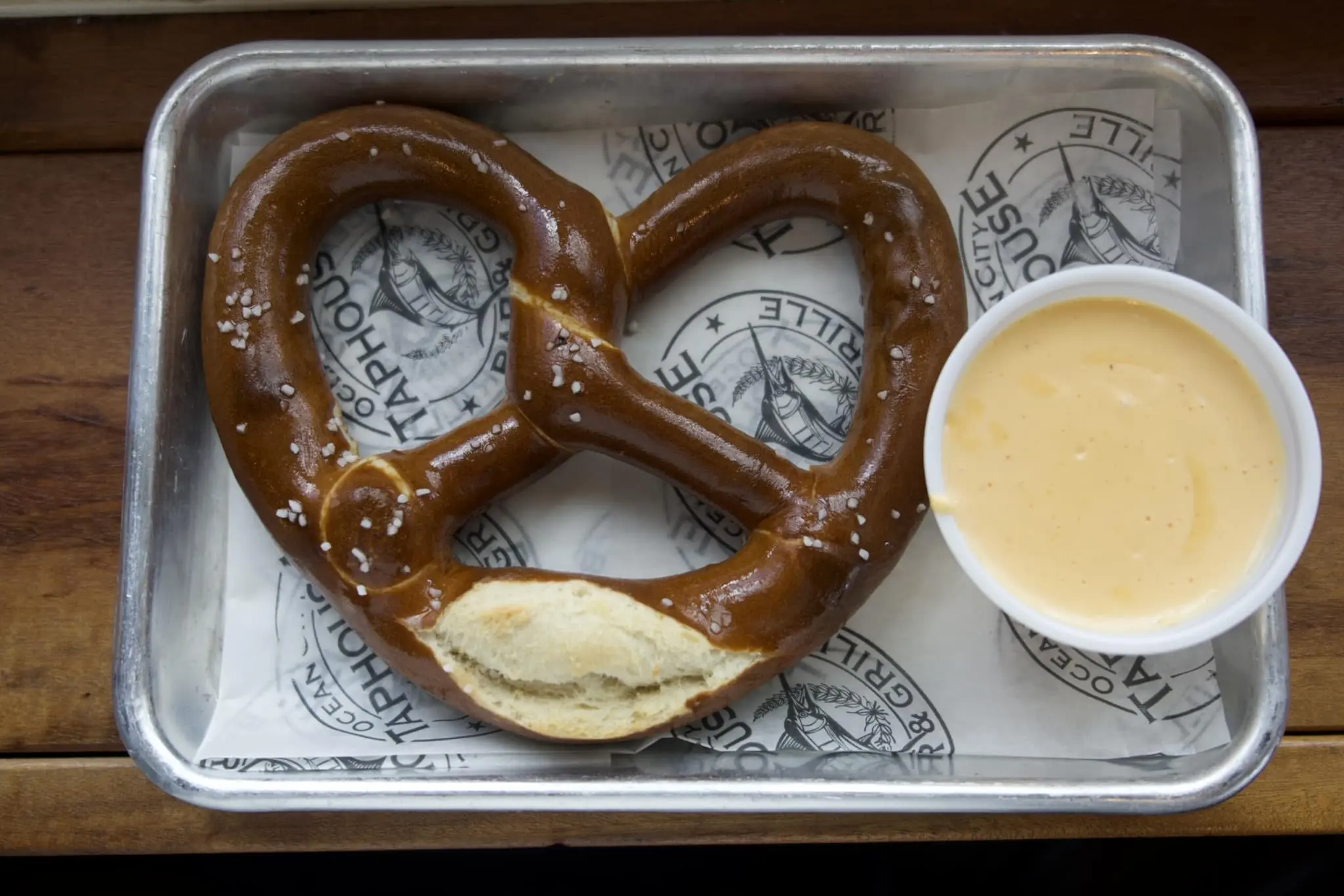 a pretzel shaped like a heart and a cup of coffee